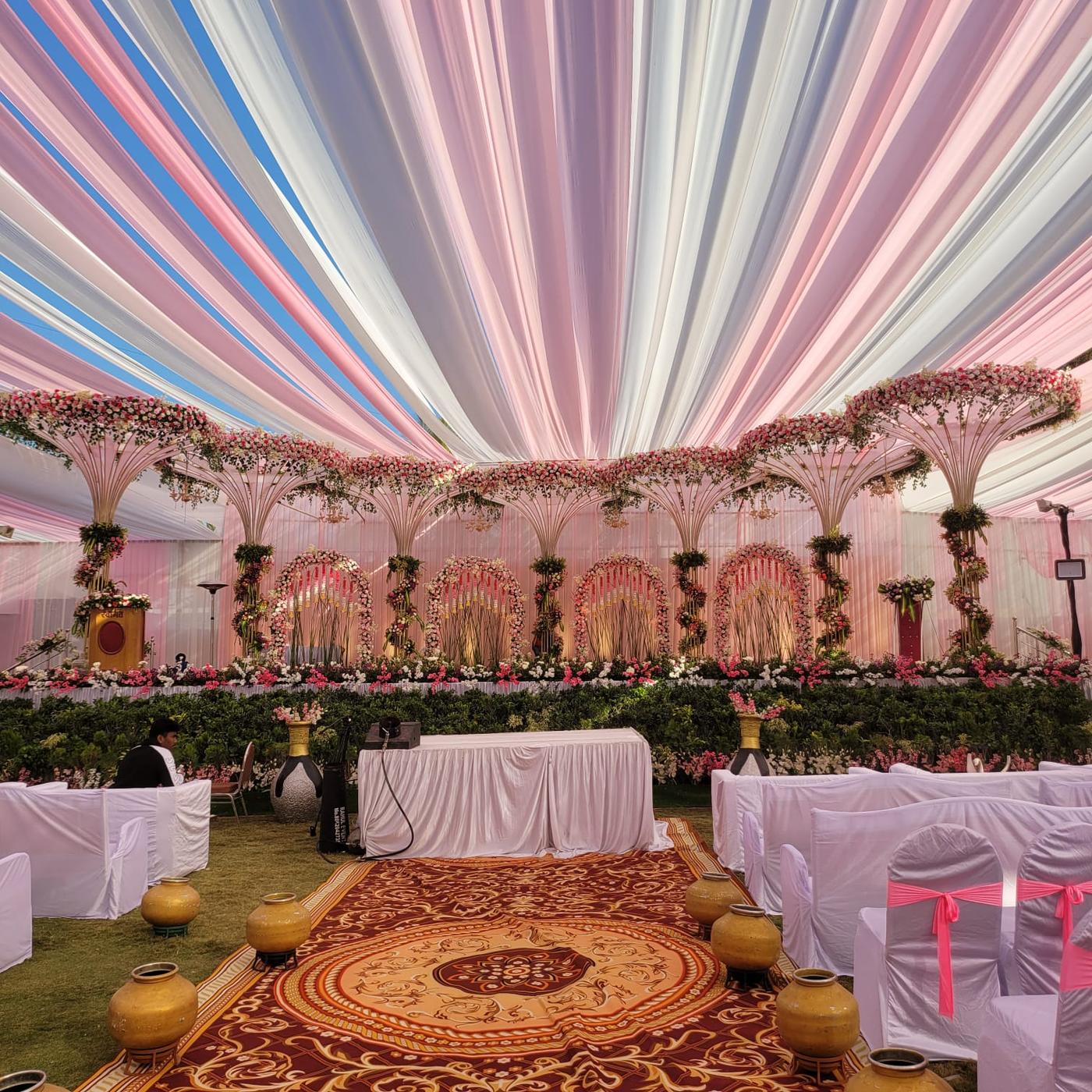 Pink drape ceiling flower arch wedding